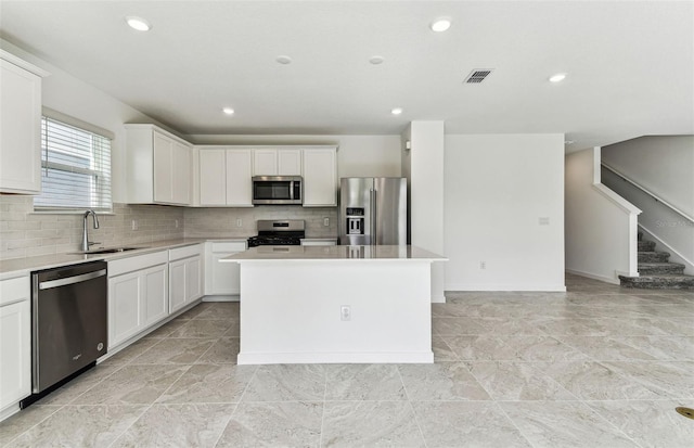 10328 Cross River Trl, Parrish, FL 34219 - kitchen featuring visible vents, a sink, decorative backsplash, and stainless steel appliances