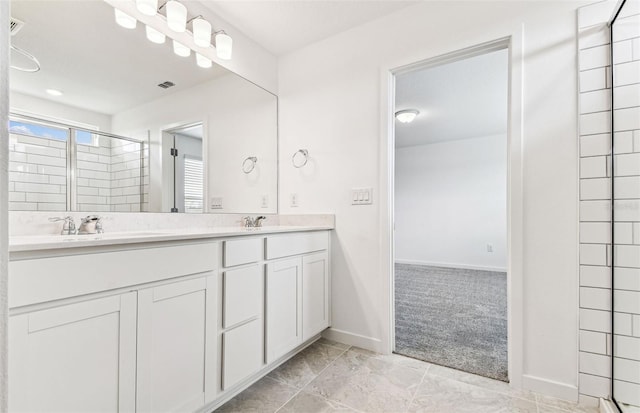 10328 Cross River Trl, Parrish, FL 34219 - full bathroom featuring double vanity, visible vents, a shower stall, a sink, and baseboards