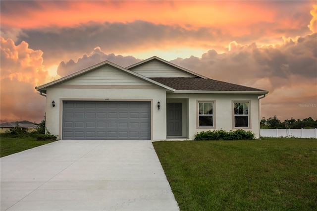 449 Grant Blvd, Lehigh Acres, FL 33974 - ranch-style home featuring driveway, an attached garage, stucco siding, and roof with shingles