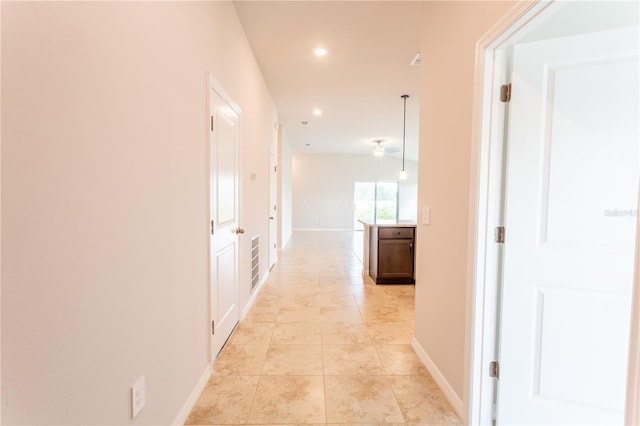 hall featuring light tile patterned flooring