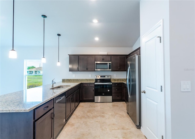 kitchen featuring kitchen peninsula, dark brown cabinets, stainless steel appliances, sink, and hanging light fixtures