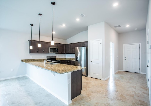 kitchen with dark brown cabinetry, light stone counters, kitchen peninsula, decorative light fixtures, and appliances with stainless steel finishes