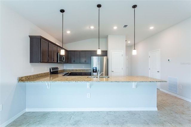 kitchen with kitchen peninsula, vaulted ceiling, decorative light fixtures, dark brown cabinetry, and stainless steel appliances