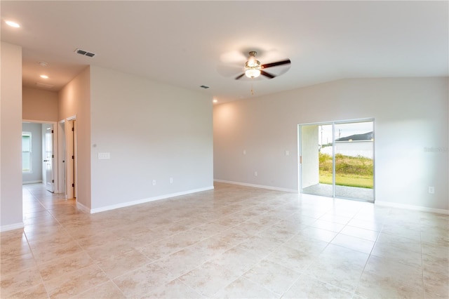 tiled spare room with vaulted ceiling and ceiling fan