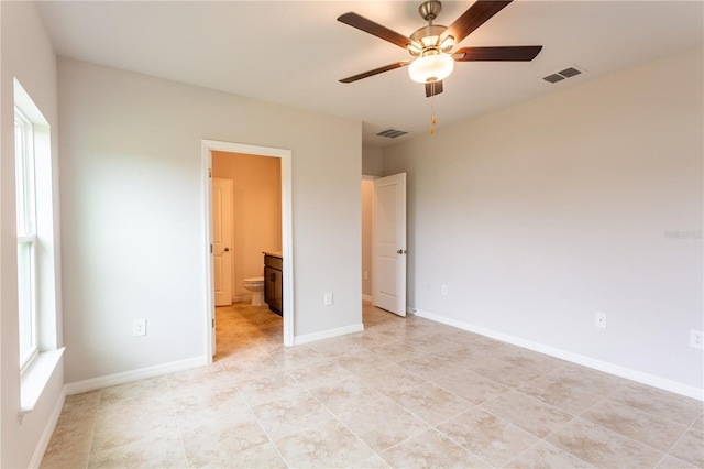 unfurnished bedroom with ensuite bath, ceiling fan, and light tile patterned flooring