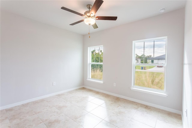 unfurnished room featuring ceiling fan and light tile patterned flooring