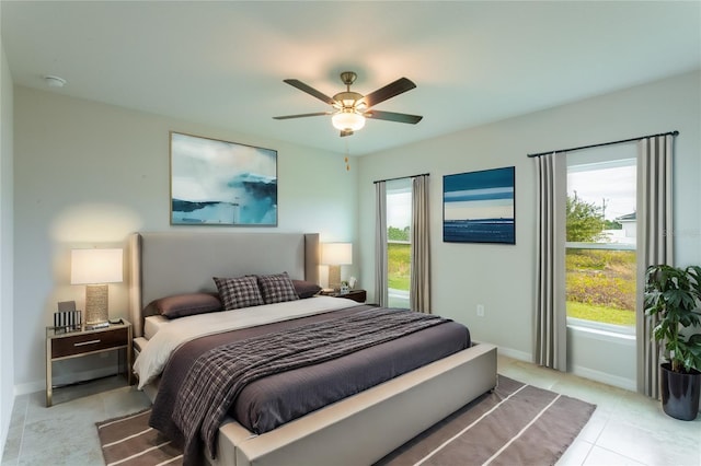 tiled bedroom featuring ceiling fan