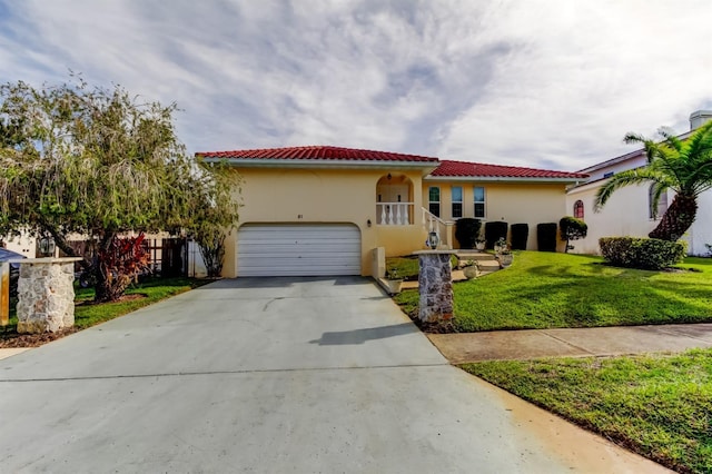 mediterranean / spanish-style home with a front yard and a garage