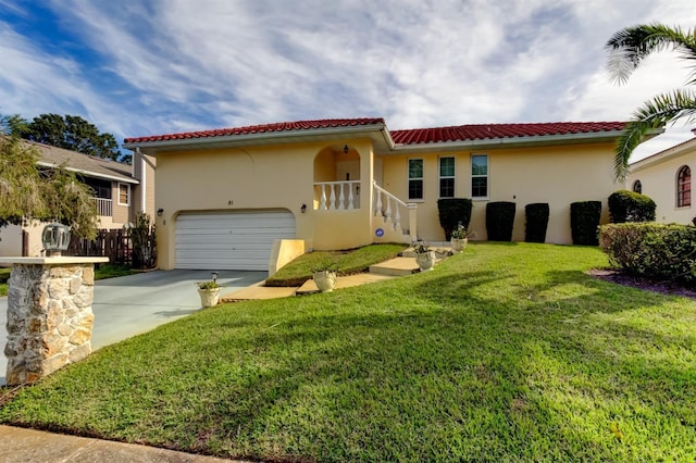 mediterranean / spanish-style house featuring a garage and a front yard