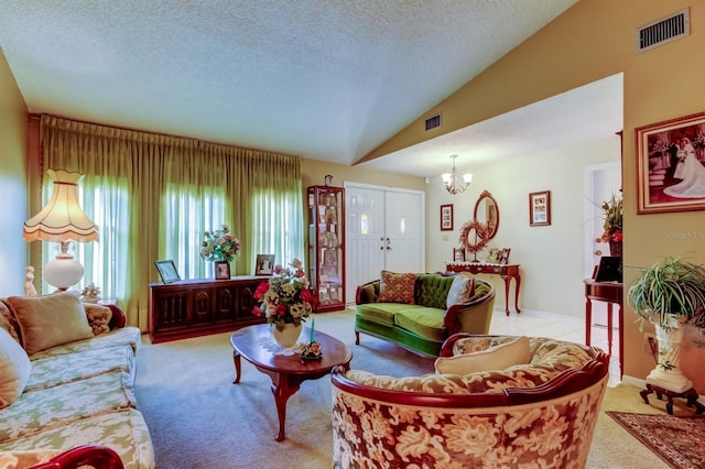 carpeted living room featuring a chandelier, a textured ceiling, and lofted ceiling