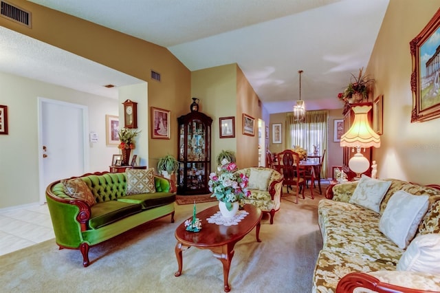 living room with a chandelier, carpet floors, and vaulted ceiling