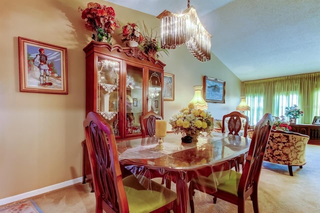 carpeted dining room featuring lofted ceiling and a notable chandelier