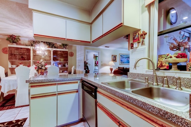 kitchen with stainless steel dishwasher, white cabinets, kitchen peninsula, and sink