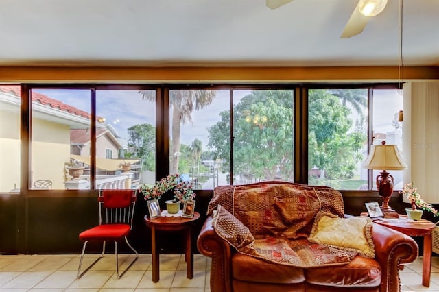 sunroom featuring ceiling fan