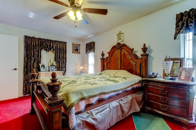 carpeted bedroom featuring a textured ceiling and ceiling fan