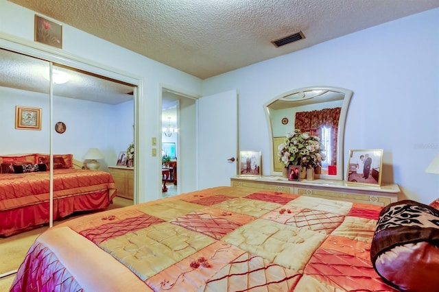 bedroom with a closet, carpet, and a textured ceiling