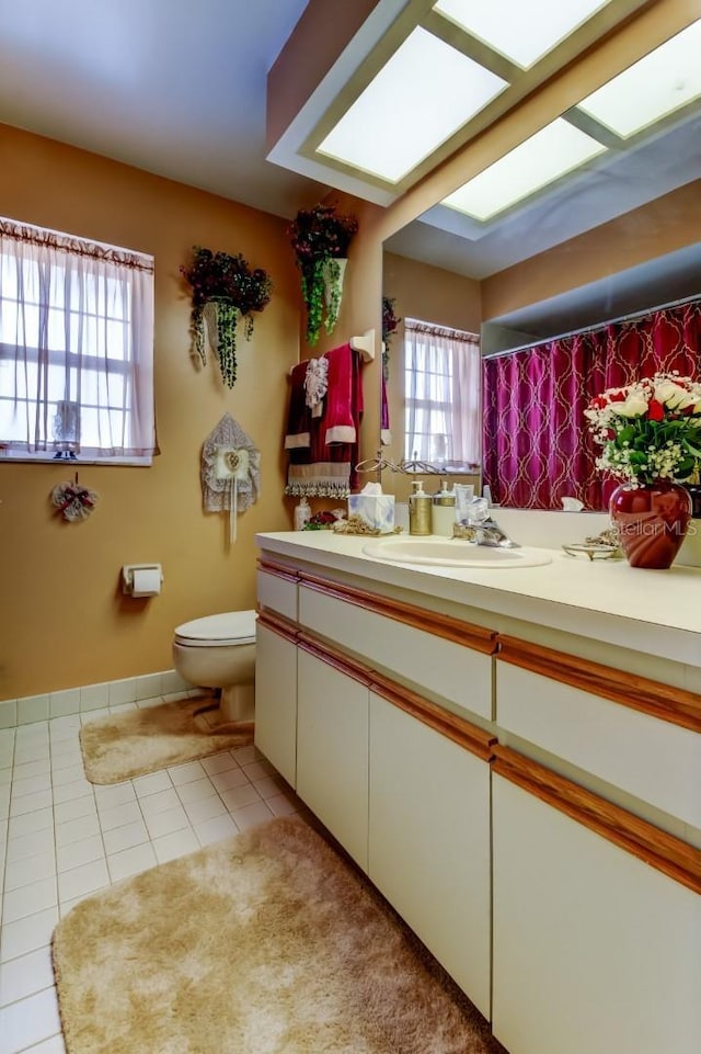 bathroom featuring tile patterned floors, vanity, and toilet