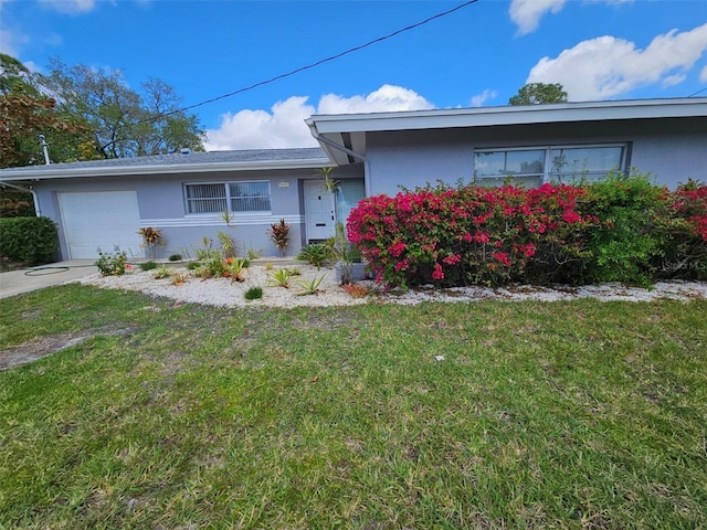 ranch-style home with a front lawn and a garage