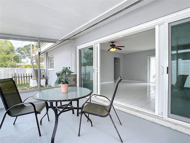 sunroom featuring ceiling fan and a healthy amount of sunlight