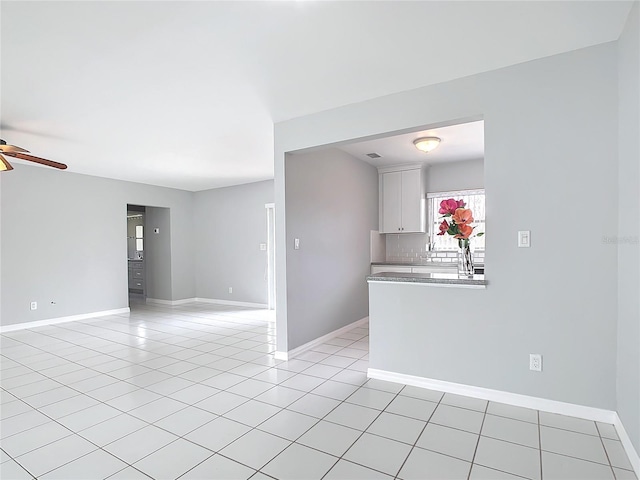 interior space with ceiling fan