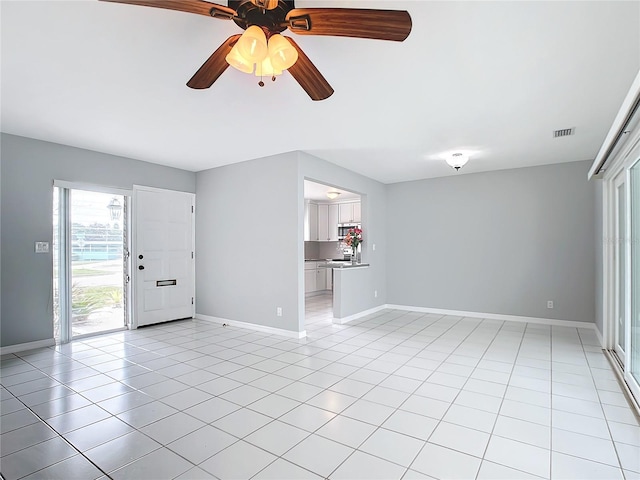 interior space featuring ceiling fan and light tile patterned flooring