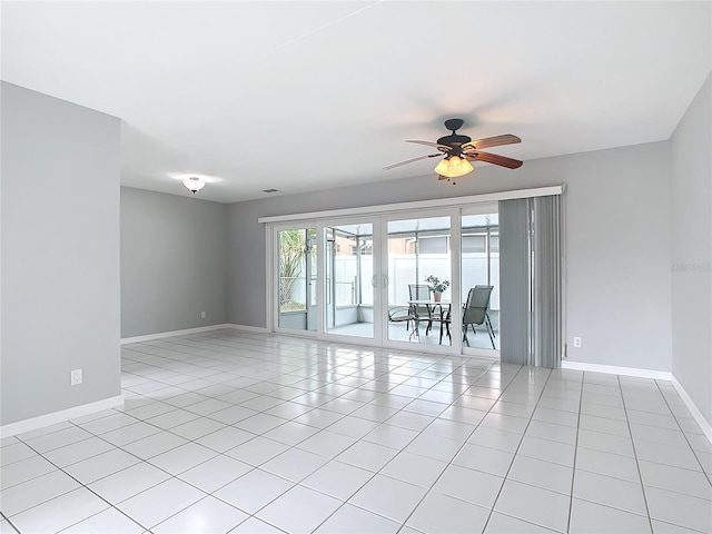 tiled empty room with ceiling fan