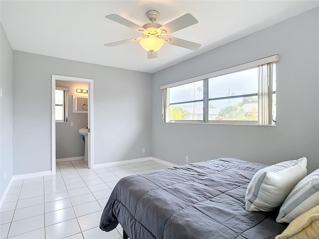 bedroom with connected bathroom, ceiling fan, and light tile patterned flooring