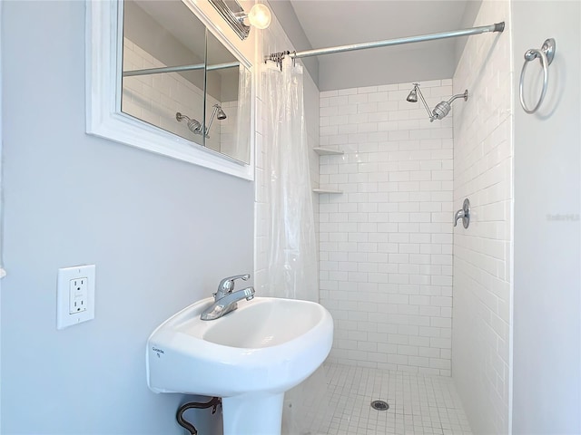 bathroom with a shower with curtain and sink