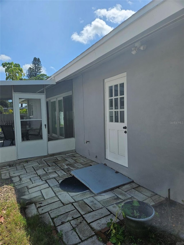 entrance to property featuring a patio area