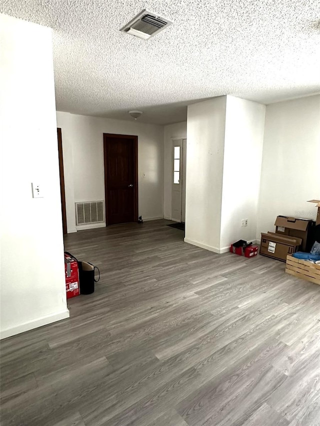 interior space with hardwood / wood-style floors and a textured ceiling