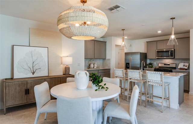 dining space with an inviting chandelier