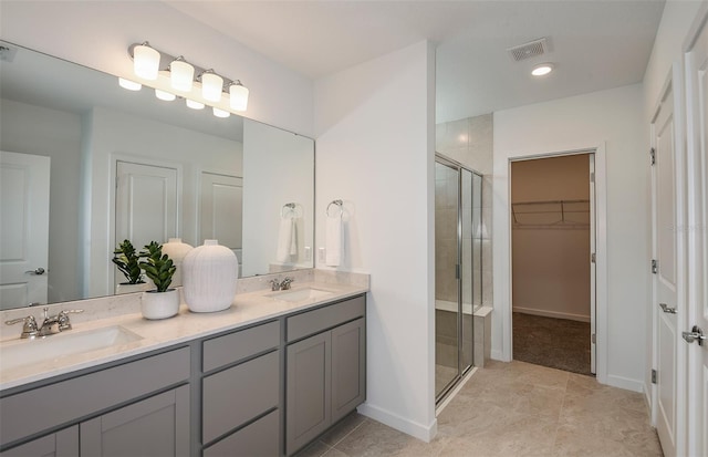 bathroom featuring vanity and a shower with door