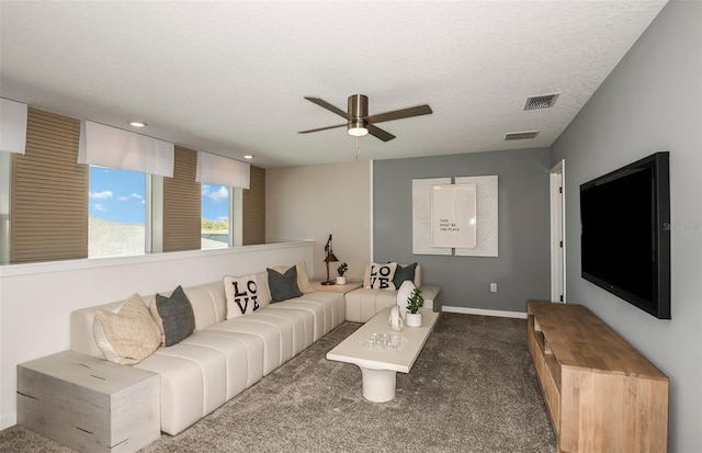 carpeted living room with a textured ceiling and ceiling fan