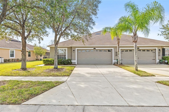 ranch-style house featuring a front yard and a garage