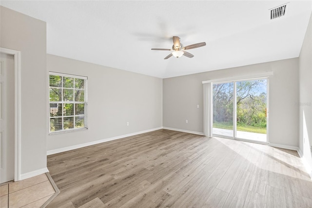 spare room featuring light hardwood / wood-style floors, plenty of natural light, and ceiling fan