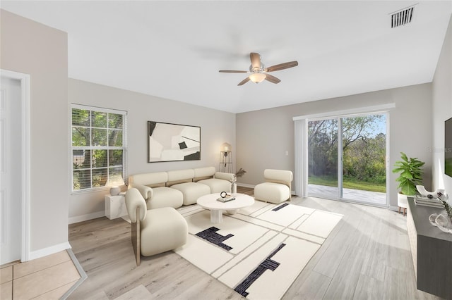 living room with ceiling fan and light hardwood / wood-style floors