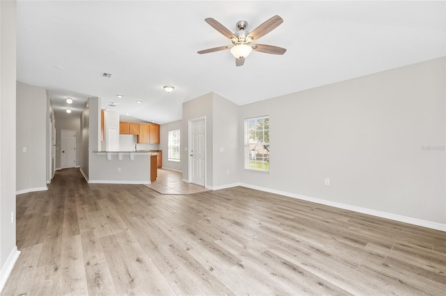 unfurnished living room with light hardwood / wood-style floors and ceiling fan