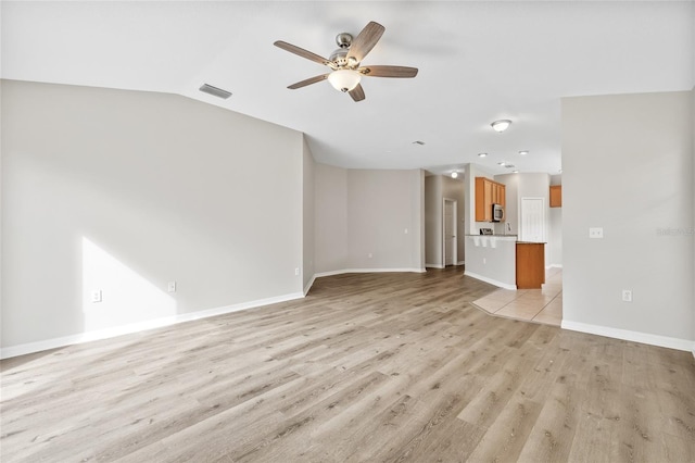 unfurnished living room featuring light hardwood / wood-style floors, ceiling fan, and lofted ceiling