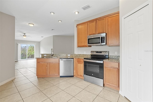 kitchen featuring kitchen peninsula, appliances with stainless steel finishes, ceiling fan, sink, and light tile patterned floors