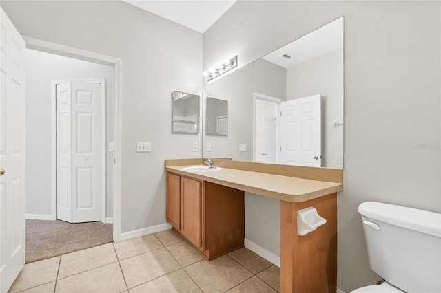 bathroom with tile patterned floors, vanity, and toilet