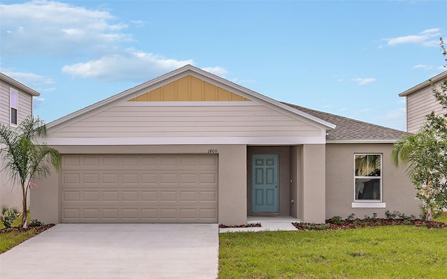 view of front of home featuring a garage and a front yard