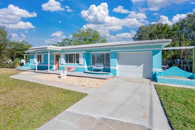 ranch-style home featuring a garage, a front yard, and covered porch