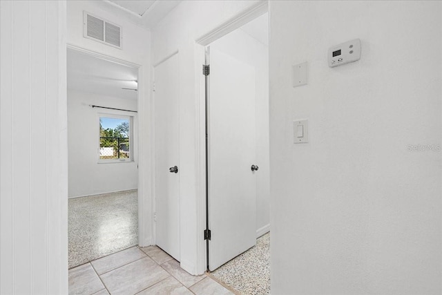 hall featuring light tile patterned floors