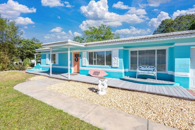 back of house with a yard and a porch