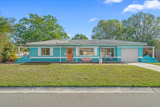 view of front facade with a tiled roof, concrete driveway, a garage, and a front yard