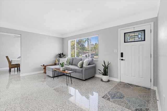 living room with speckled floor and baseboards