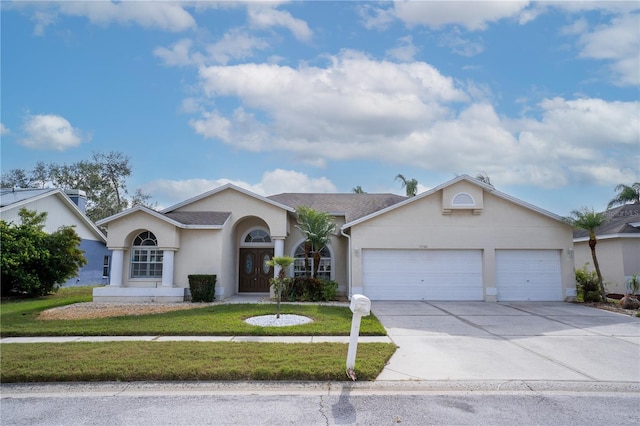 single story home featuring a front yard and a garage