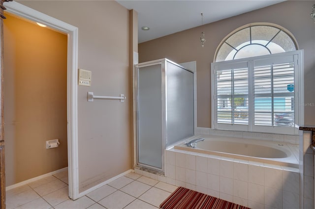 bathroom featuring plenty of natural light, plus walk in shower, and tile patterned flooring