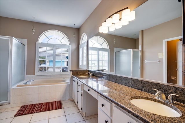 bathroom with vanity, tile patterned flooring, and plus walk in shower