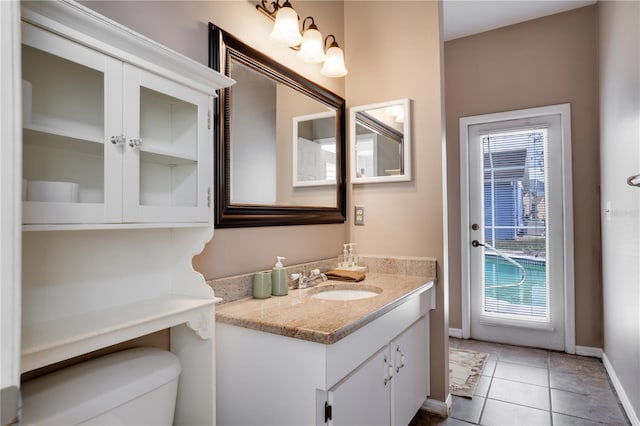 bathroom with tile patterned floors, vanity, and toilet